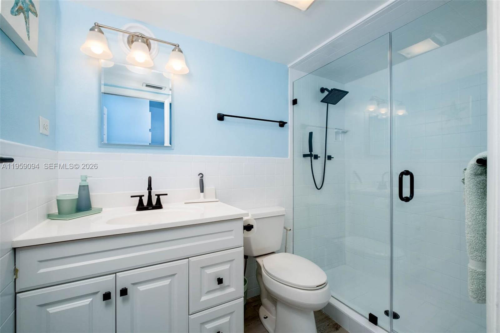 410 10th Street Key Colony Beach, FL 33051 - Photo 19 of 62 a bathroom with a sink a toilet and a mirror
