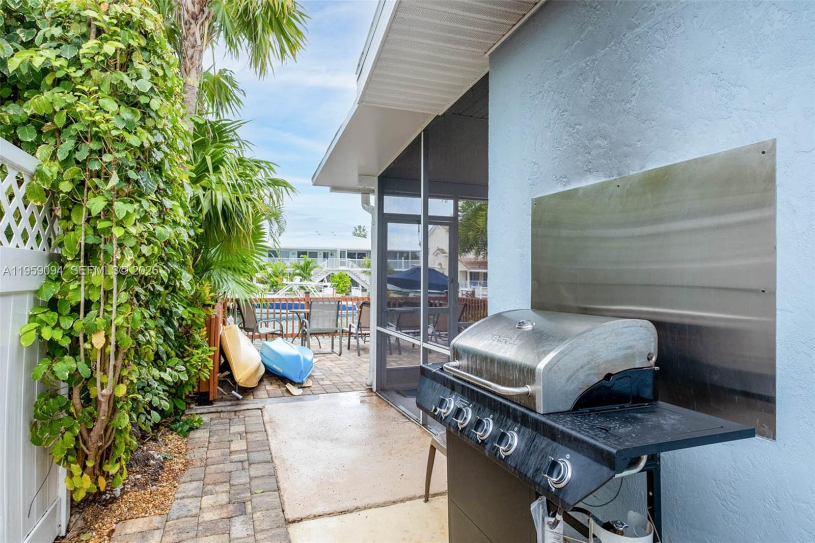 410 10th Street Key Colony Beach, FL 33051 - Photo 27 of 62 a balcony with furniture and a potted plant