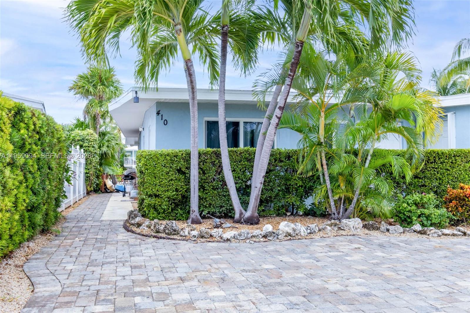 410 10th Street Key Colony Beach, FL 33051 - Photo 3 of 62 a front view of a house with garden