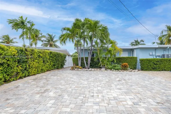 a view of a house with a yard and plant