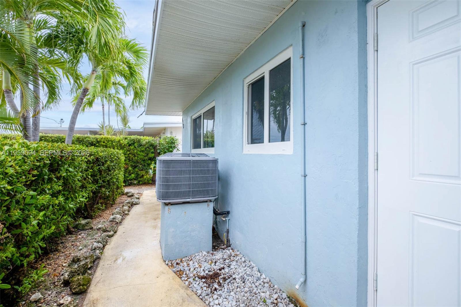 410 10th Street Key Colony Beach, FL 33051 - Photo 32 of 62 a front view of a house with garden