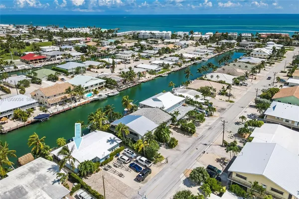 an aerial view of a houses with a yard