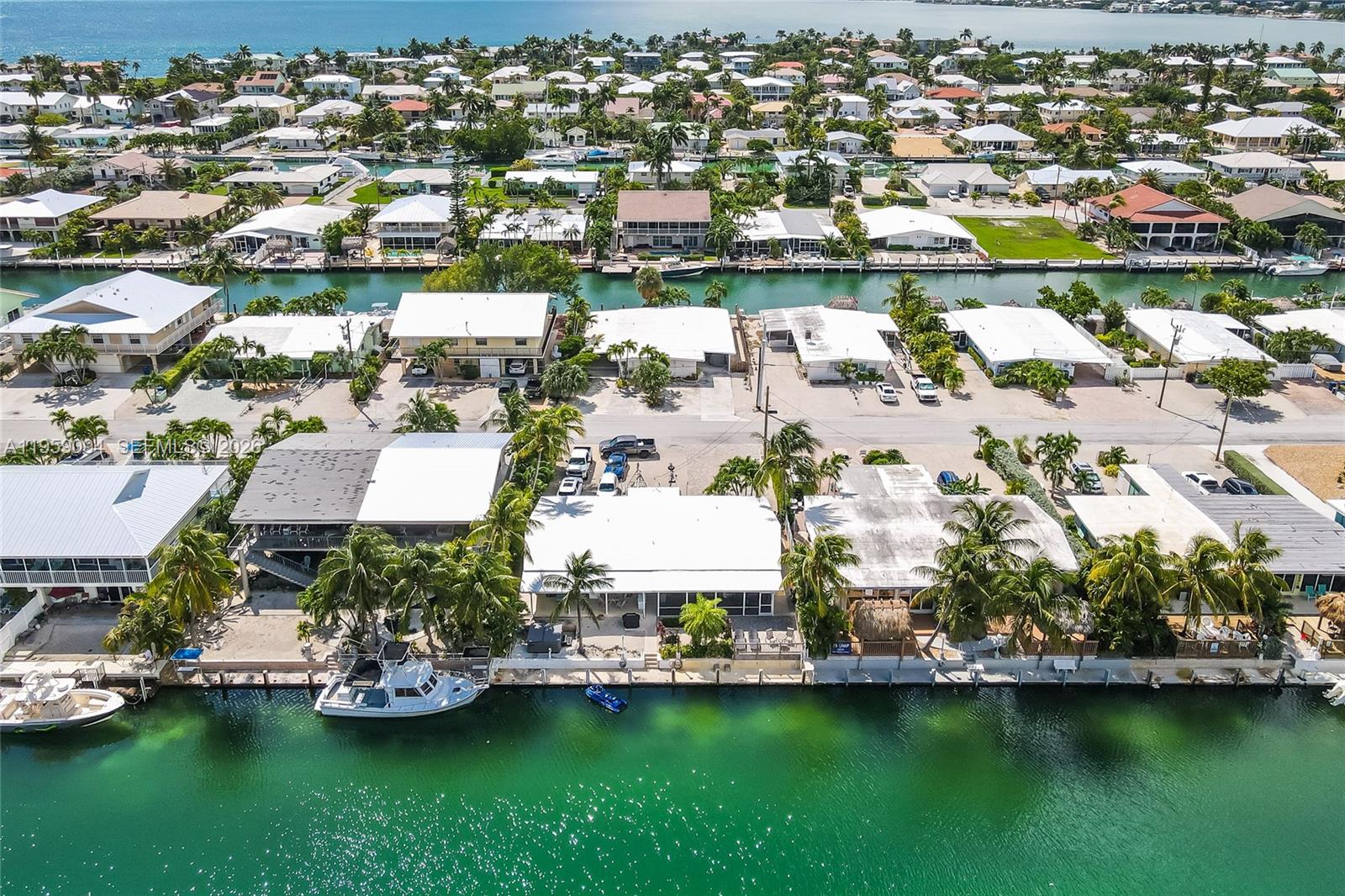 410 10th Street Key Colony Beach, FL 33051 - Photo 48 of 62 an aerial view of a house with a garden and lake view