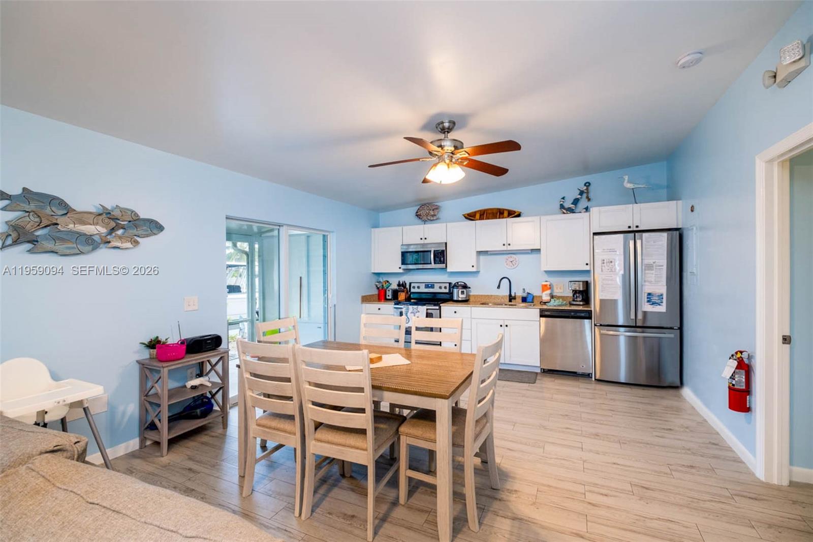410 10th Street Key Colony Beach, FL 33051 - Photo 5 of 62 a view of a dining room with furniture and wooden floor