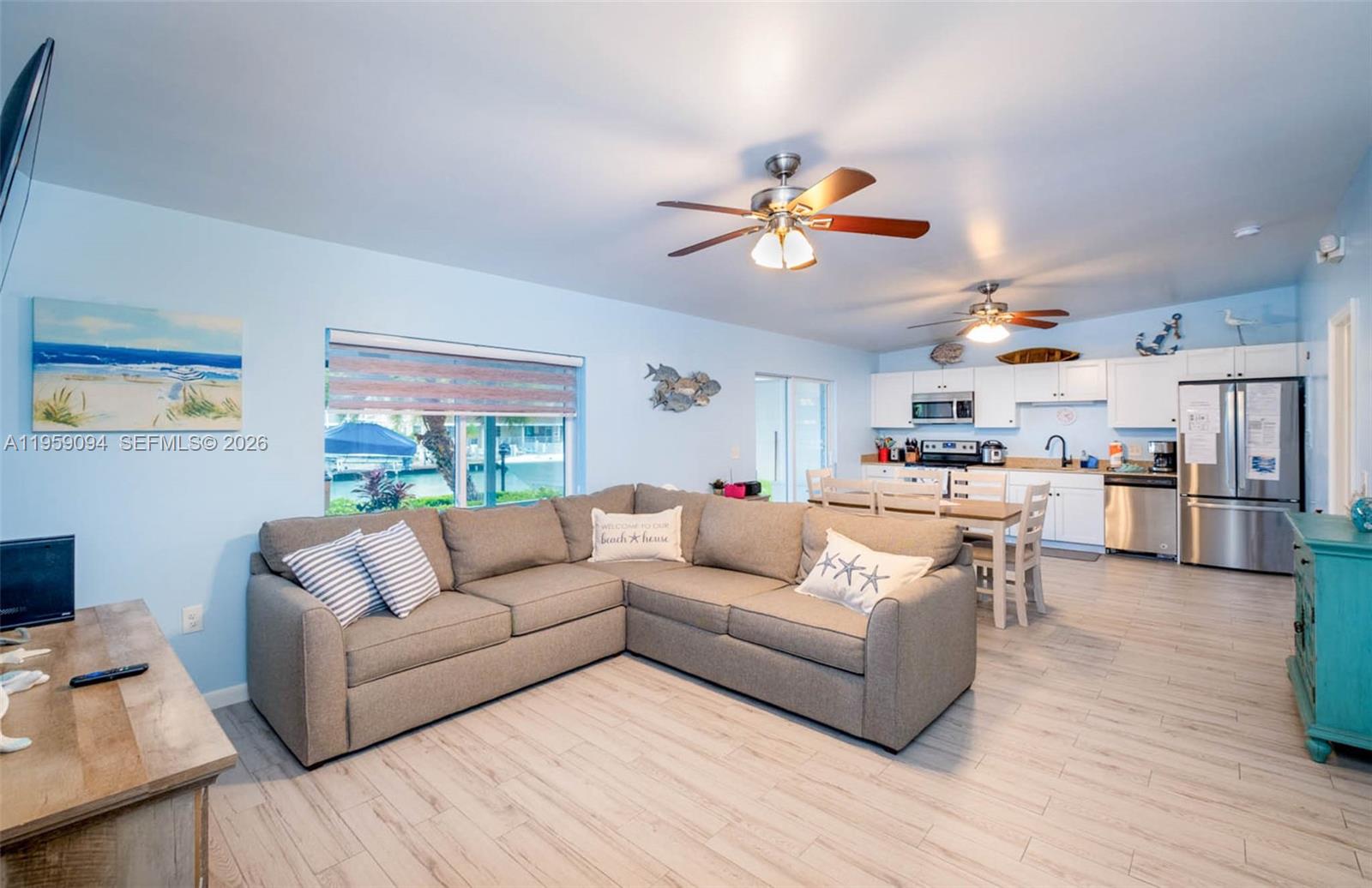 410 10th Street Key Colony Beach, FL 33051 - Photo 5 of 62 a living room with furniture kitchen view and a chandelier