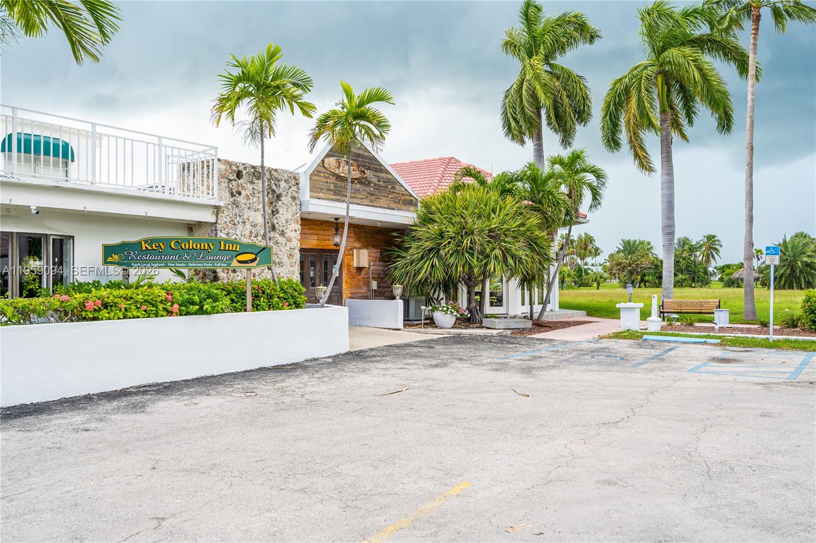 410 10th Street Key Colony Beach, FL 33051 - Photo 53 of 62 a view of a house with a yard and palm trees