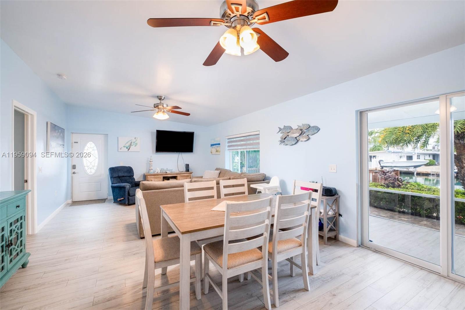 410 10th Street Key Colony Beach, FL 33051 - Photo 10 of 62 a view of a dining room with furniture window and wooden floor