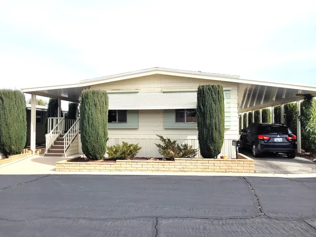a view of a car park in front of house