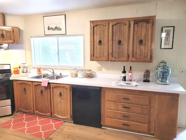 a kitchen with stainless steel appliances a stove a sink and a refrigerator