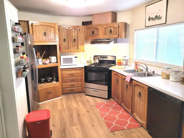 a living room with kitchen island furniture and a kitchen view