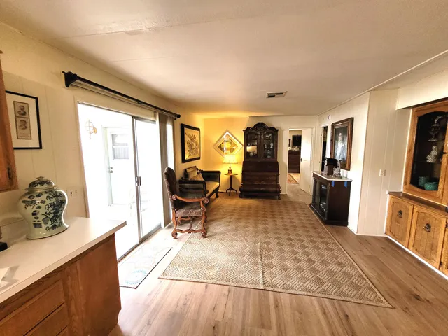 a living room with furniture and a fireplace with wooden floor