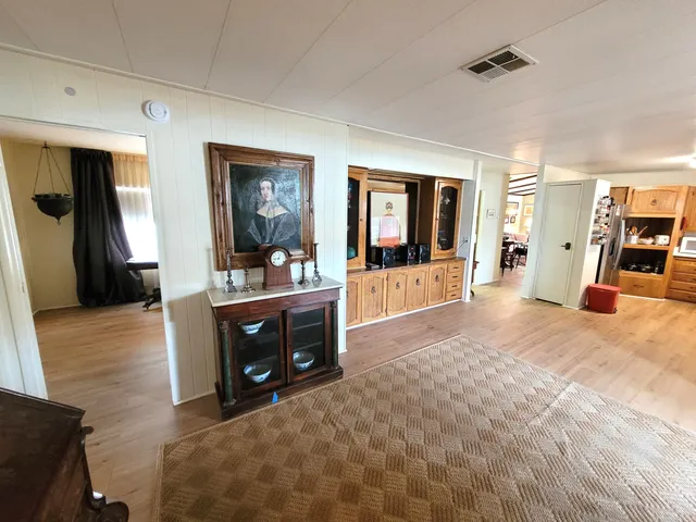 a living room with stainless steel appliances kitchen island granite countertop furniture and a view of kitchen