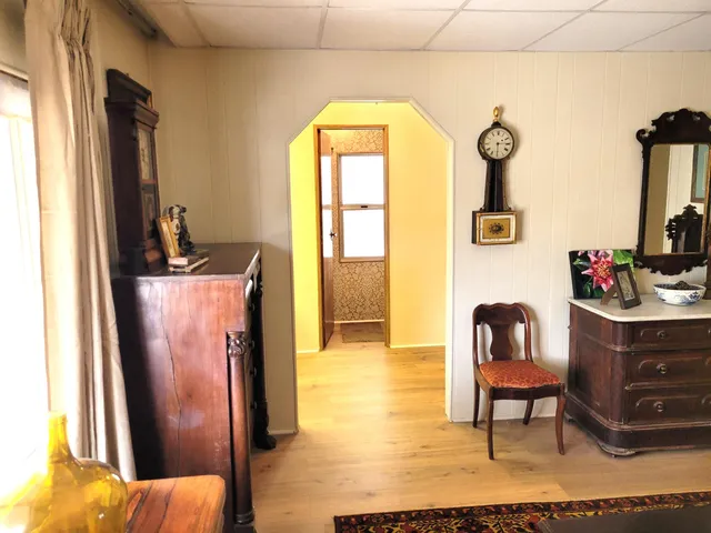 a bed room with a bed furniture and a flat tv screen