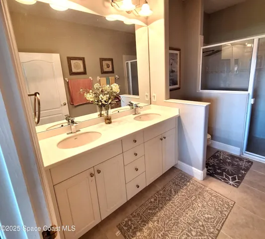 a bathroom with a double vanity sink and mirror