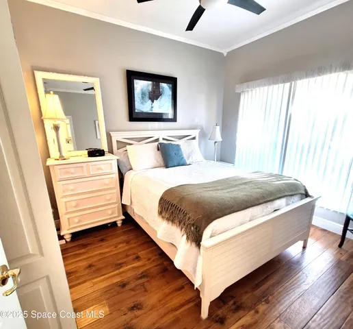 a bedroom with a bed and a large mirror