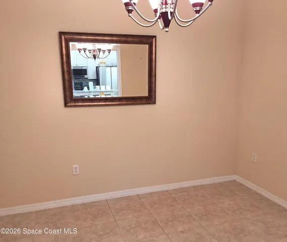 a view of a small space with wooden floor and a window