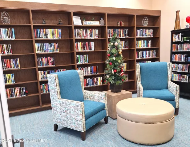 a living room with furniture and a book shelf