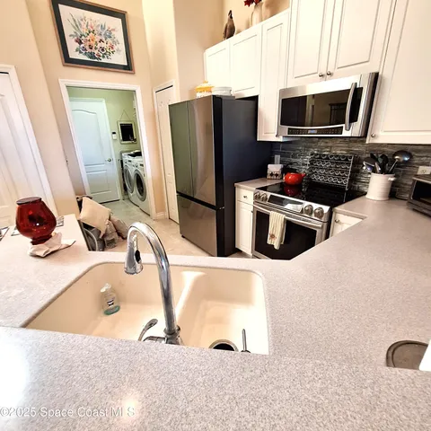 a kitchen with a sink and a stove top oven