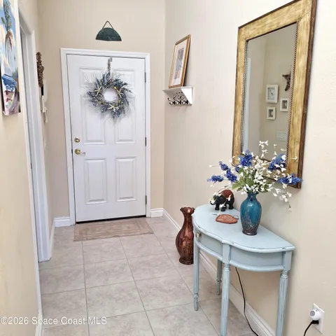 a view of bathroom with a sink and mirror