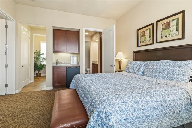 a bedroom with a bed and cabinets