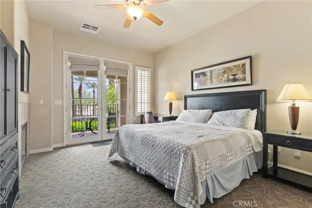 a spacious bedroom with a bed and a lamp with window