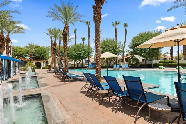 a swimming pool with outdoor seating