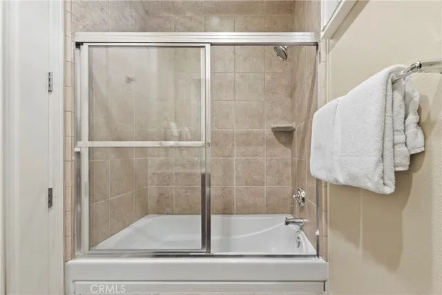 a bathroom with a bathtub and shower
