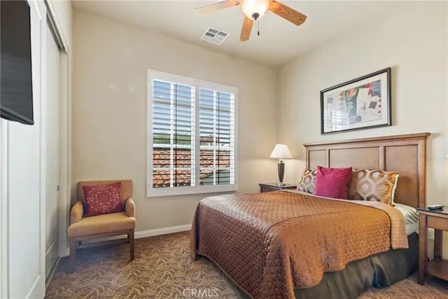 a spacious bedroom with a bed and a couch