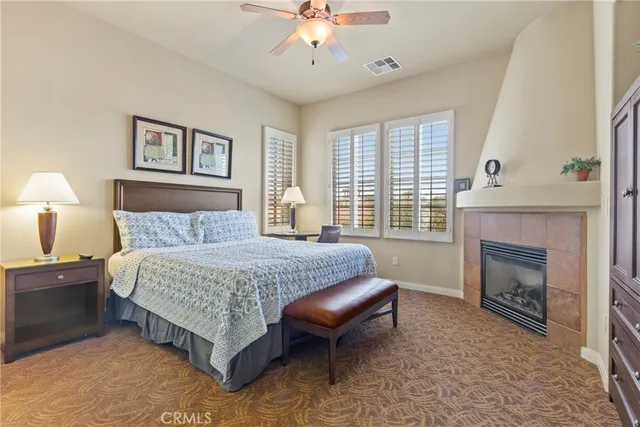 a spacious bedroom with a bed and a fireplace