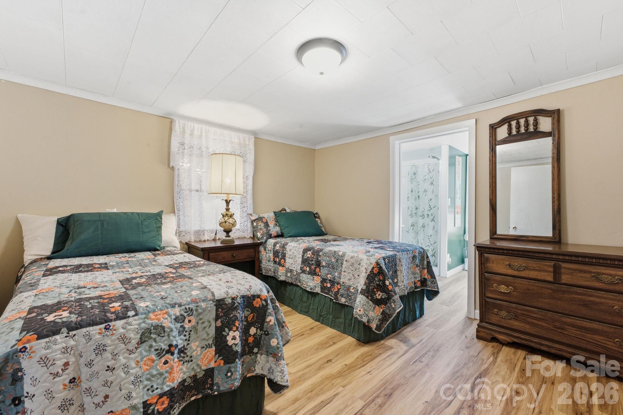 583 Dark Ridge Road Sylva, NC 28779 - Photo 33 of 48 a bedroom with two beds and painting on the wall
