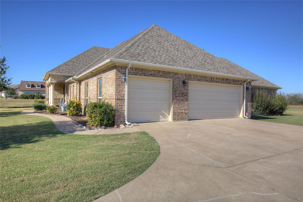 1066 Canyon Lake Road Wills Point, TX 75169 - Photo 26 of 40 a front view of a house with a yard and garage