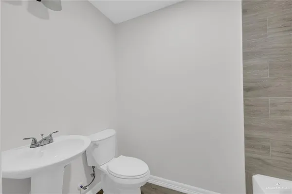 a white toilet sitting next to a white sink