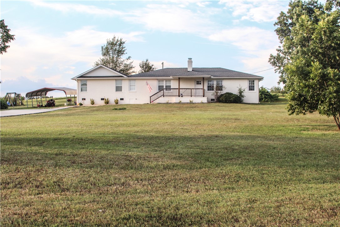757 Belle Shoals Road Pickens, SC 29671 - Photo 2 of 31 A classic white ranch home with a welcoming front porch set on a verdant, open lot.