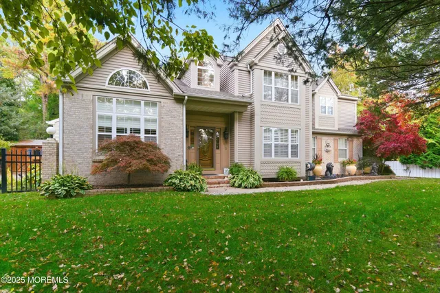 a front view of a house with a garden and yard