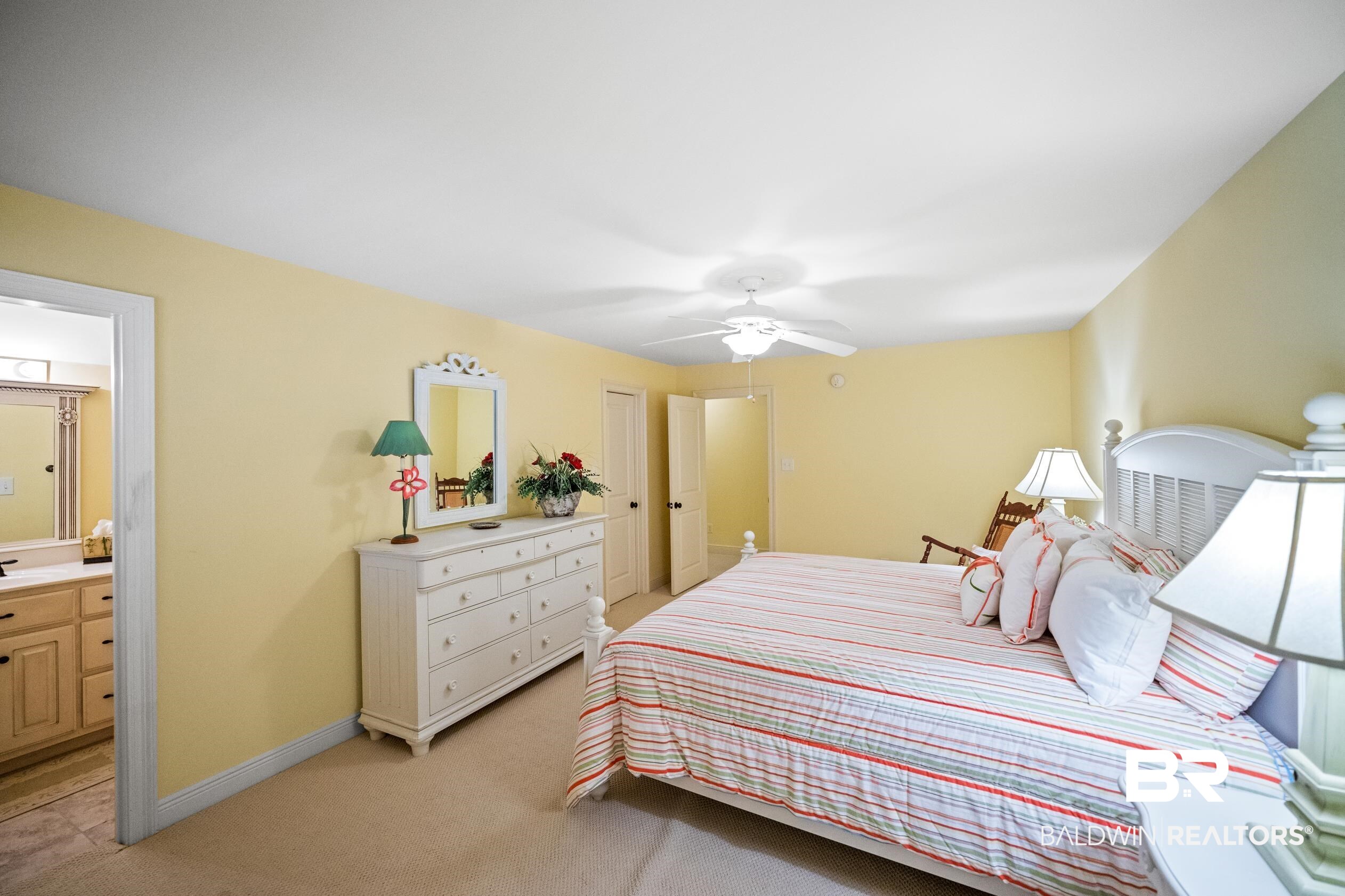 404 Peninsula Boulevard Gulf Shores, AL 36542 - Photo 15 of 51 Bedroom with light carpet, a ceiling fan, and ensuite bathroom