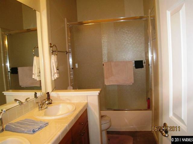 1664 Sewell Drive Reno, NV 89521 - Photo 9 of 13 a bathroom with a sink and a mirror