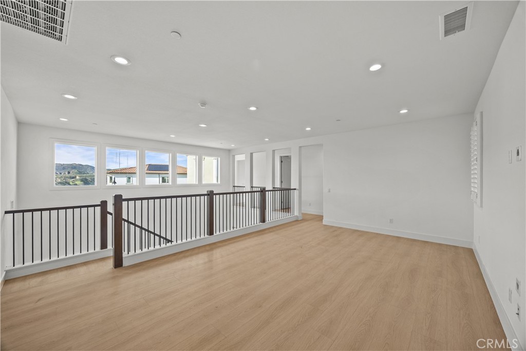 20638 Deer Grass Court Porter Ranch, CA 91326 - Photo 24 of 50 a view of an empty room with wooden floor