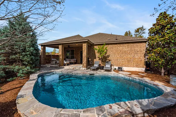a view of a house with backyard porch and sitting area