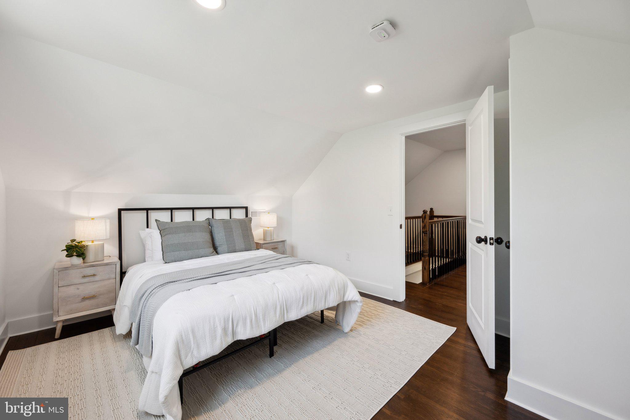 4007 35th Street Mount Rainier, MD 20712 - Photo 20 of 49 a bedroom with a bed and wooden floor
