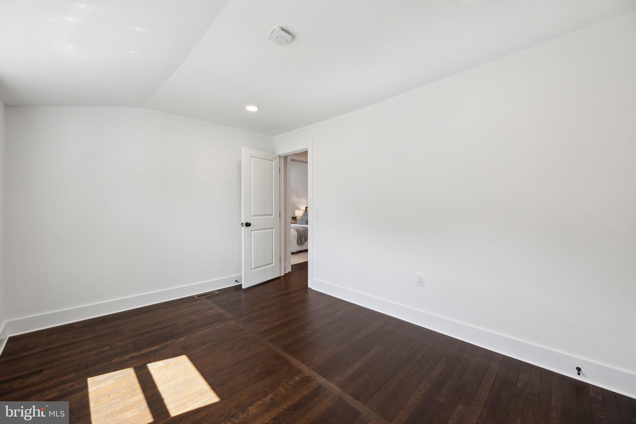 4007 35th Street Mount Rainier, MD 20712 - Photo 24 of 49 an empty room with wooden floor and windows