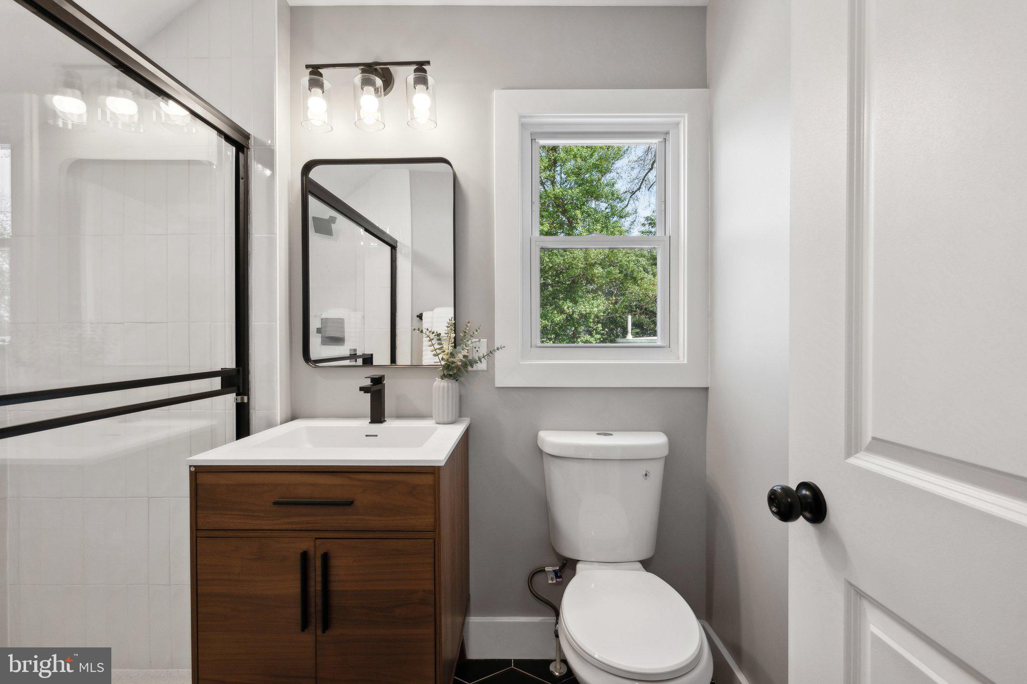 4007 35th Street Mount Rainier, MD 20712 - Photo 26 of 49 a bathroom with a toilet sink and mirror
