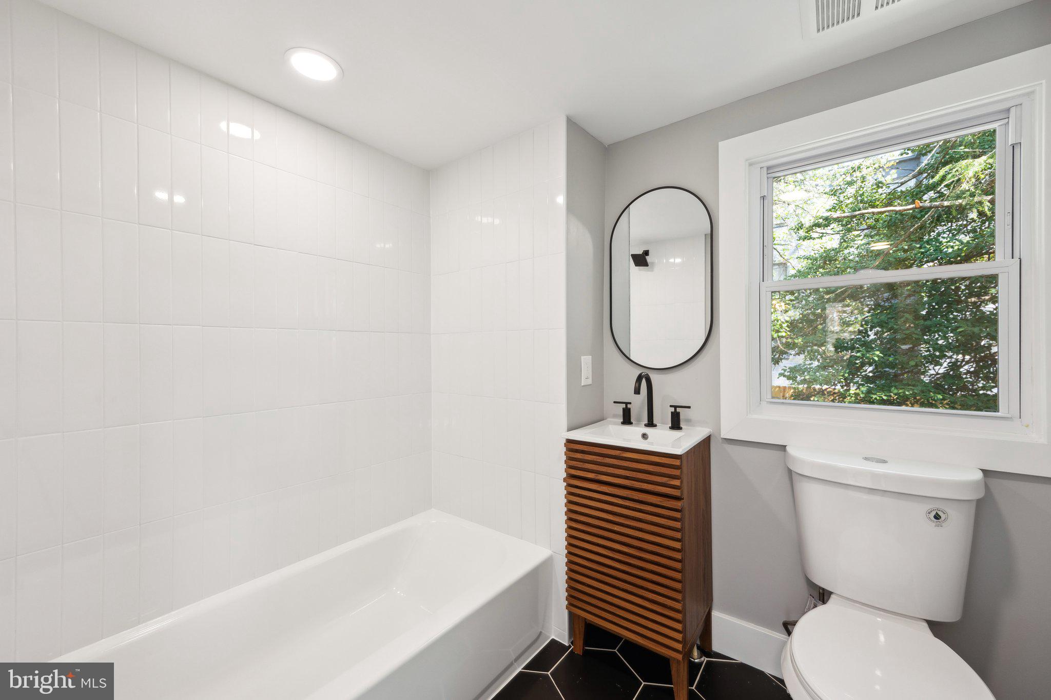4007 35th Street Mount Rainier, MD 20712 - Photo 33 of 49 a bathroom with a sink toilet and a bathtub