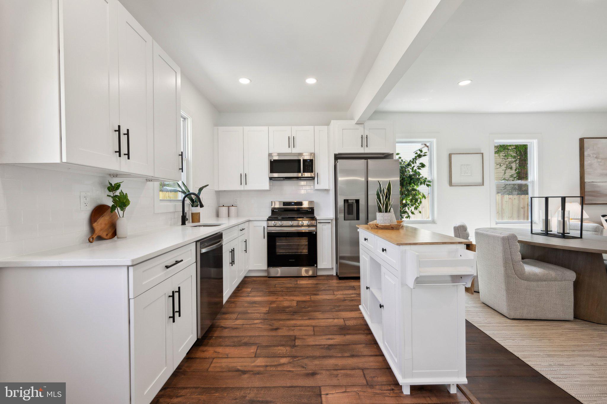 4007 35th Street Mount Rainier, MD 20712 - Photo 8 of 49 a kitchen with stainless steel appliances a sink dishwasher stove refrigerator and cabinets