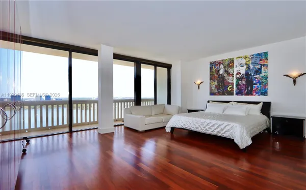 a bedroom with a large bed and a couch