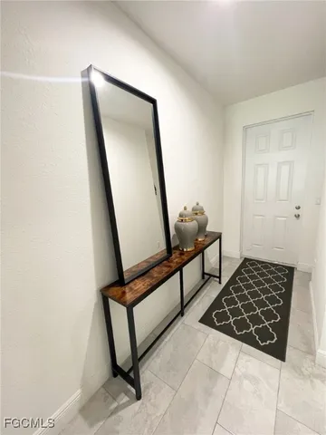 a room with rug and white walls