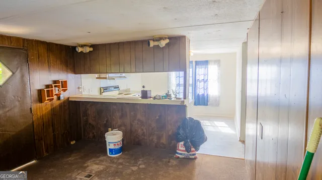 a view of an entryway with wooden floor and a livingroom