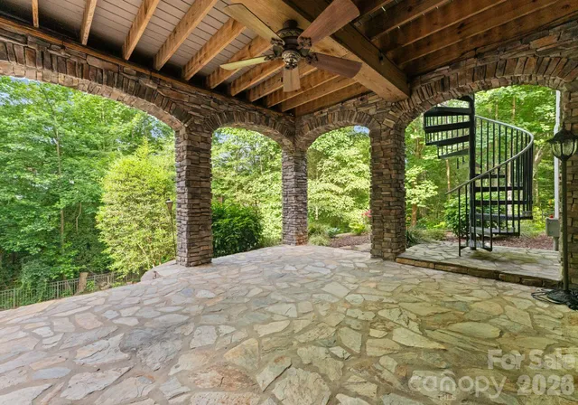 a view of a backyard with a garden and seating area