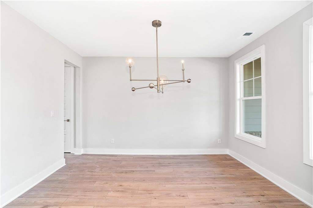 2596 Parkside Way Gainesville, GA 30507 - Photo 12 of 33 a view of a room with wooden floor and a window
