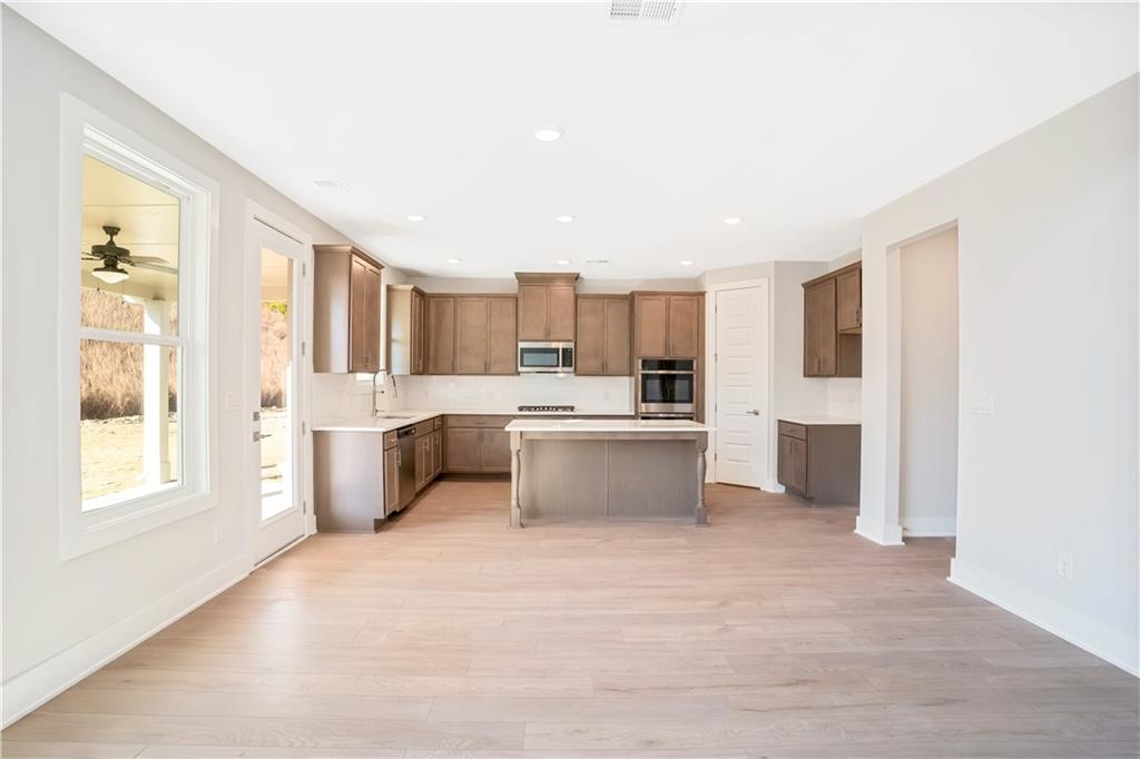 2596 Parkside Way Gainesville, GA 30507 - Photo 17 of 27 a large white kitchen with a large window