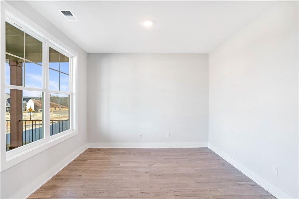 2596 Parkside Way Gainesville, GA 30507 - Photo 19 of 27 a view of an empty room with wooden floor and a window